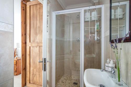 a bathroom with a shower and a sink at #5A on Brassie in Lakeside