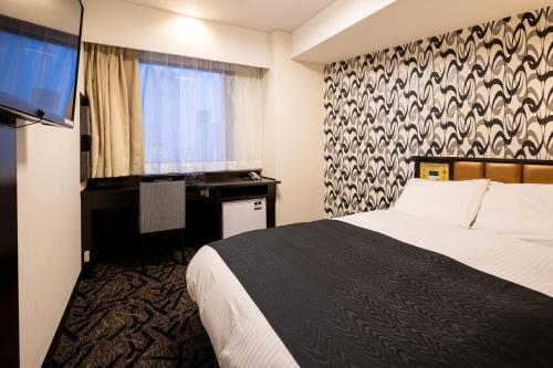 Postel nebo postele na pokoji v ubytování APA Hotel Koriyama Ekimae