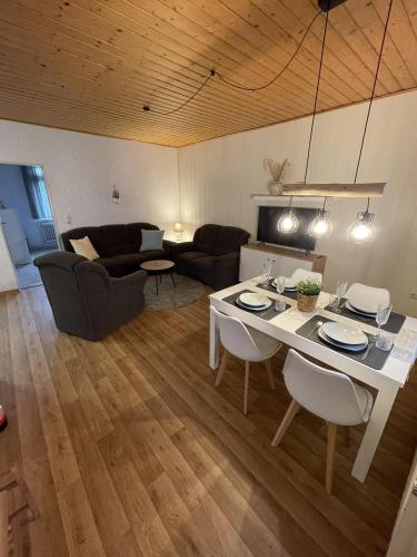 a living room with a table and chairs and a couch at In't Noord Kombüse in Tossens