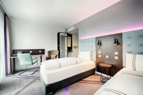 a bedroom with a white bed and a desk at Premier Inn Wiesbaden City Centre in Wiesbaden