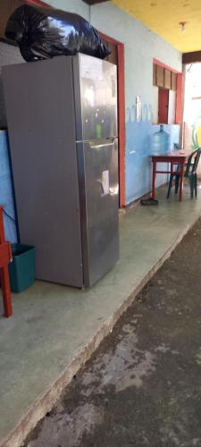 a stainless steel refrigerator in a room with a table at House Zope in Panajachel