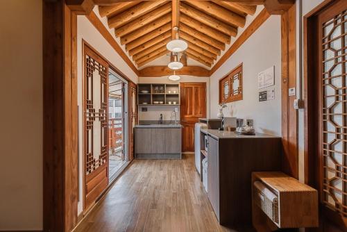 a kitchen with wooden walls and a wooden ceiling at Luxury Hanok Cottage Nest in Seoul