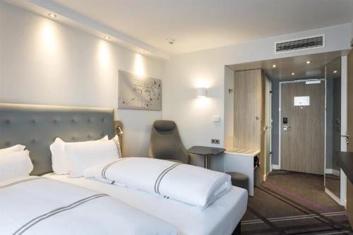 a hotel room with a bed and a desk at Premier Inn Freiburg City Süd in Freiburg im Breisgau