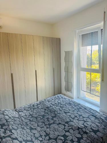 an empty bedroom with a bed and a window at sole in Novara