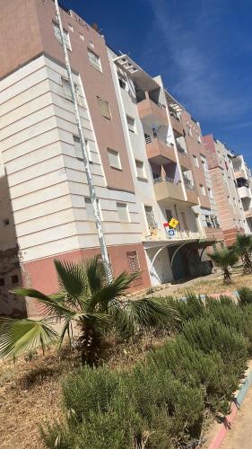 a tall building with a ladder on the side of it at Appart familial moderne de luxe Location journalière ou longue durée in Khemisset