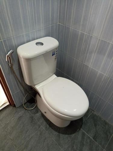 a bathroom with a white toilet in a room at Joglo Hexa in Bugisan