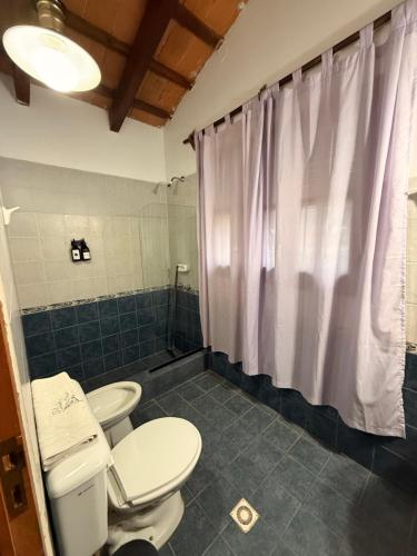 a bathroom with two toilets and a shower at La Posada De Juan in Coronel Moldes