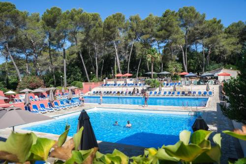 a pool at a resort with people swimming in it at Belambra Clubs La Colle-sur-Loup - Les Terrasses De Saint-Paul De Vence in La Colle-sur-Loup