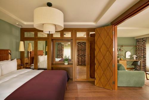a bedroom with a bed and a chair in a room at Sir Devonshire Square Hotel, part of Sircle Collection in London