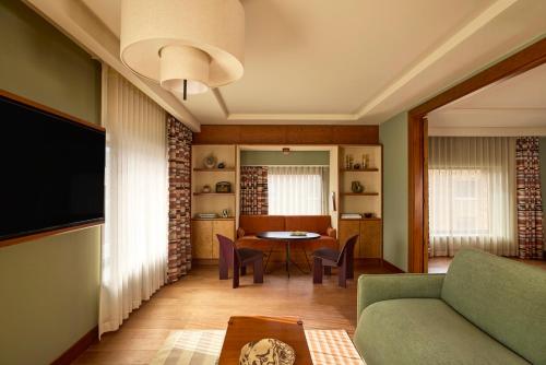 a living room with a couch and a table at Sir Devonshire Square Hotel, part of Sircle Collection in London
