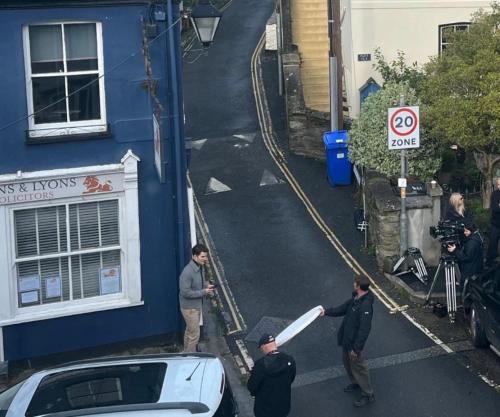 a group of people standing outside of a blue building at ON BBC1s BEYOND PARADISE - - Prospect House - - 17th Century Character COTTAGE - - CONNECTING APARTMENTS - - Kids Bunk Room - - Free Public Parking in Looe