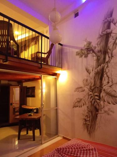 a room with a mural on the wall with a table at GT Homes Peradeniya in Peradeniya