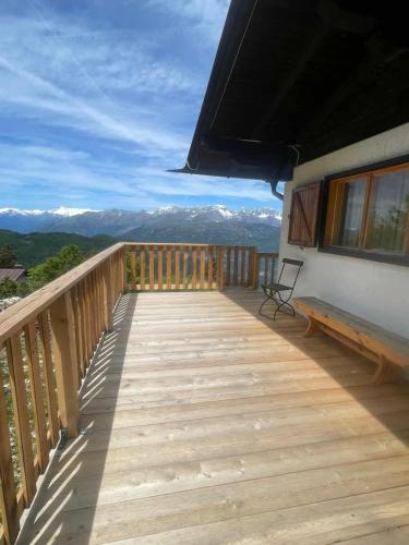 a wooden balcony with a view of mountains at Casa nel Bosco in Trento