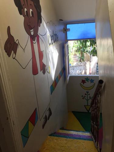 a room with a wall with a painting of a chef at Gana kato in Aswan