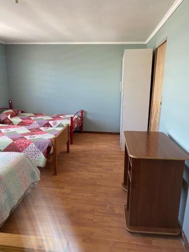 a bedroom with two beds and a dresser and a desk at House in Molina in Molina