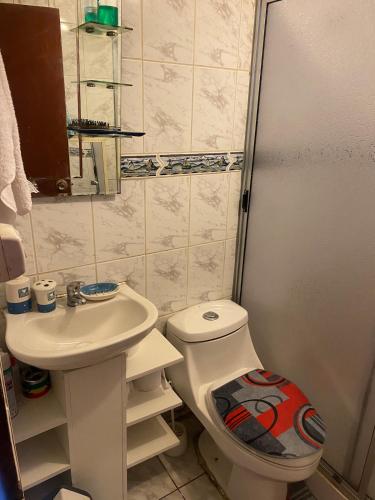 a small bathroom with a toilet and a sink at House in Molina in Molina