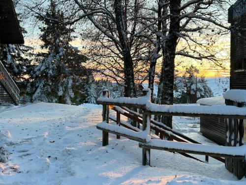 a bench covered in snow next to a house at Super Besse chez Sophie 2ch, séjour, wifi, 2tv, rdc, terrasse, parc, piscine, pkg in Besse-et-Saint-Anastaise