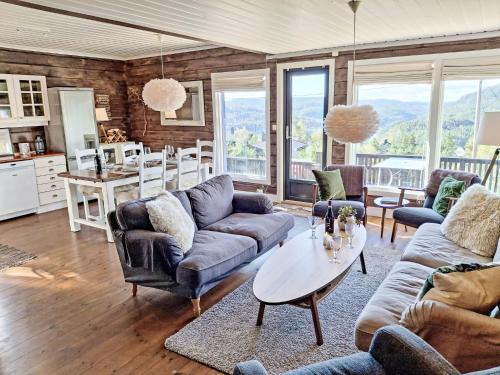 a living room with couches and a table at Holiday Home Kosestua by Interhome in Madland