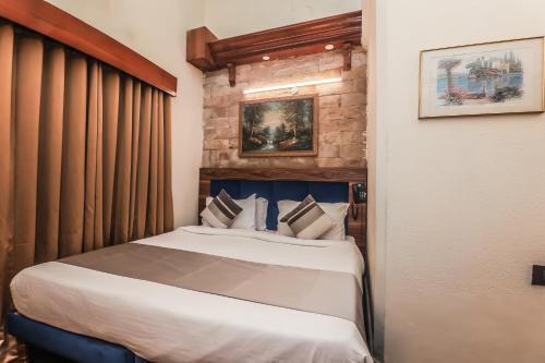 a bedroom with a bed in a room at asar CP Outer Circle by Orion Hotels in New Delhi