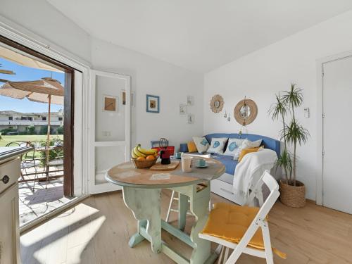 a living room with a table and a couch at Apartment Iris 5- Terza Spiaggia by Interhome in Golfo Aranci