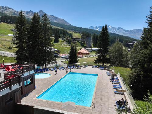 an overhead view of a swimming pool in a resort at Belambra Clubs Arc 1800 - Hôtel Du Golf in Arc 1800