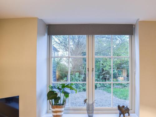 a window in a room with a plant at The Barn in Spofforth