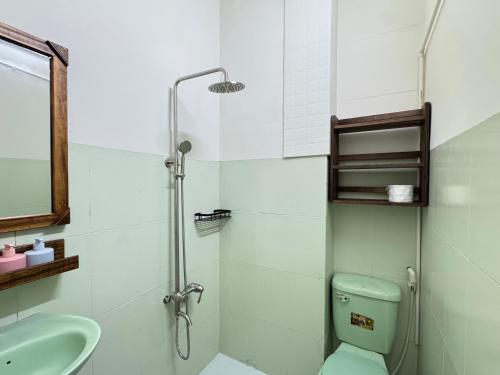 a bathroom with a shower and a toilet and a sink at An Homestay 2 in Phan Thiet