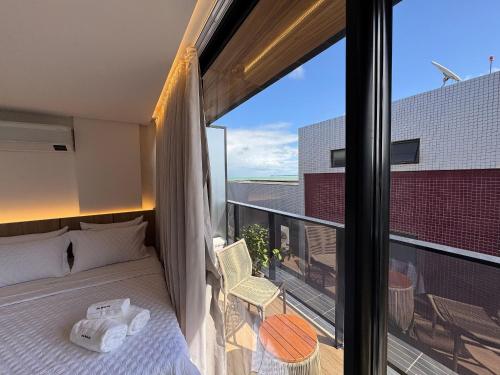 Postel nebo postele na pokoji v ubytování Flat beira-mar pé na areia com varanda