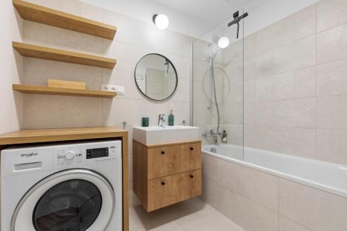 a bathroom with a washing machine and a sink at LAM Discovery AC - Balcony in Nivy
