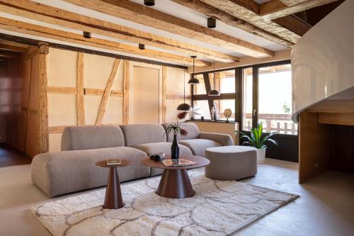 a living room with a couch and a table at The incredible Alsatian house of the 21st century in Hangenbieten