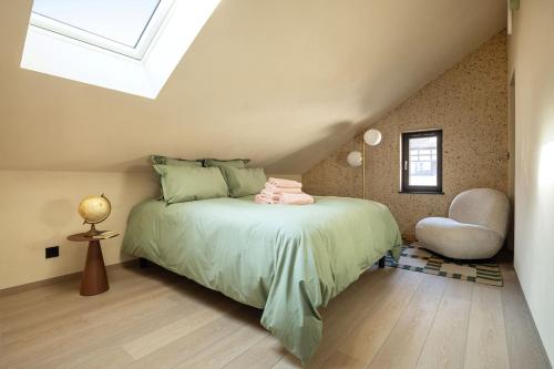 a bedroom with a bed in a attic at The incredible Alsatian house of the 21st century in Hangenbieten