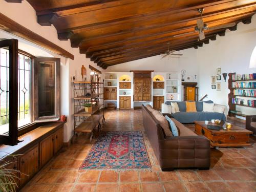 a living room with a couch and a table at Holiday Home El Comendador by Interhome in Acebuchal