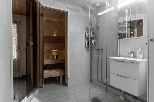a bathroom with a shower and a sink at Rovaniemi Spacious Lapland Vacation Home with Private Sauna & Lappish Fire Hut in Rovaniemi