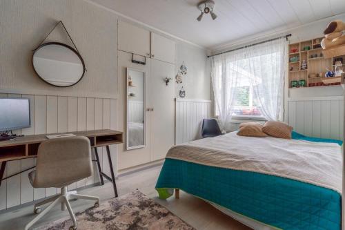 a bedroom with a bed and a desk and a computer at Rovaniemi Spacious Lapland Vacation Home with Private Sauna & Lappish Fire Hut in Rovaniemi