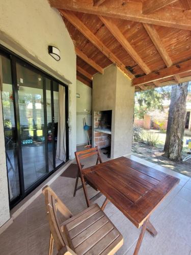 a wooden table and chairs on a patio at RIO ARRIBA in Colón