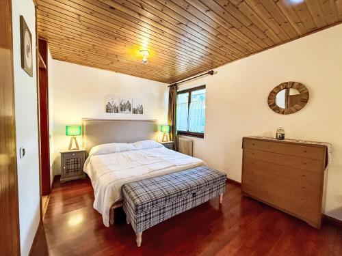 a bedroom with a bed and a wooden ceiling at Apartment Marmolada-12 by Interhome in Alba di Canazei