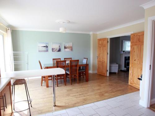 a kitchen and dining room with a table and chairs at Holiday Home Glen Ard HH No 1 by Interhome in Dunmore East