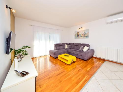 a living room with a couch and a table at Holiday Home Marija by Interhome in Primorski Dolac