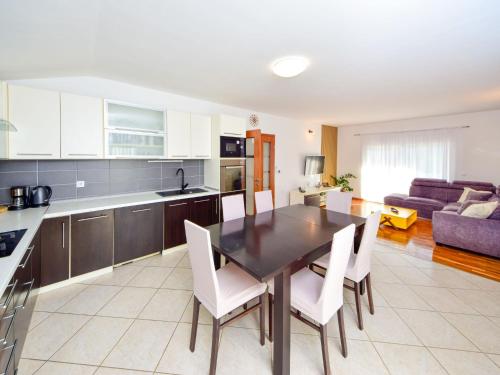 a kitchen and living room with a table and chairs at Holiday Home Marija by Interhome in Primorski Dolac