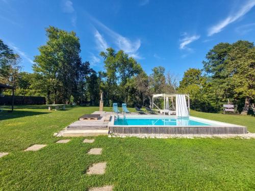 ein Schwimmbad in einem Park mit Rasenfläche in der Unterkunft Holiday Home Utinja by Interhome in Skakavac