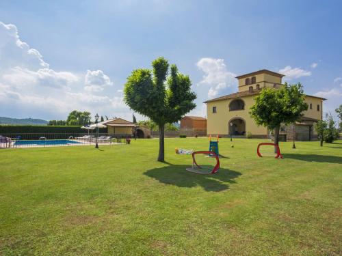 a park with two benches and a tree in the grass at Villa La Salciaia-1 by Interhome in Marciano