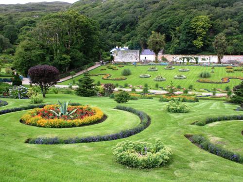 a garden with flowers and a building in the background at Holiday Home Galway Bay - TR4Lodge by Interhome in Doughiska