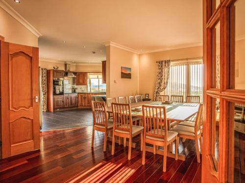 a kitchen and dining room with a table and chairs at Holiday Home Benderloch House & Frobost Lodge by Interhome in Daliburgh