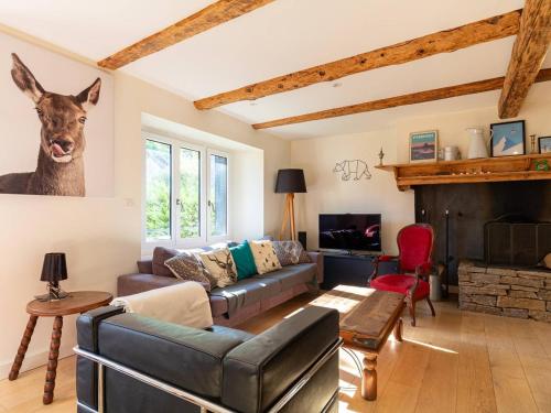 a living room with a couch and a deer head on the wall at Maison de village rénovée pour 12 pers avec jardin et jacuzzi proche Loudenvielle - FR-1-695-89 in Adervielle