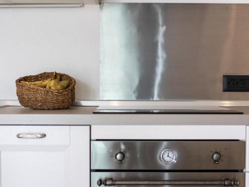 a basket of bananas sitting next to a stove in a kitchen at Holiday Home Poggio Piero 3 by Interhome in Montemassi
