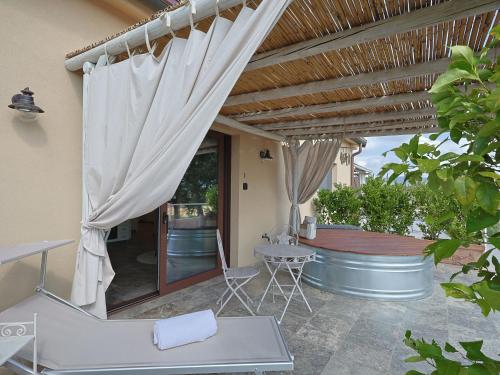 a patio with an umbrella and a table and chairs at Holiday Home Poggio Piero 3 by Interhome in Montemassi