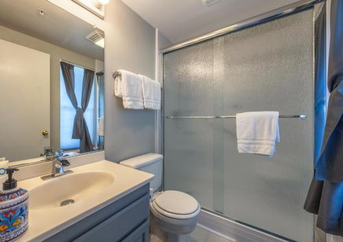 a bathroom with a shower and a sink and a toilet at Alley's 22 in Hood River