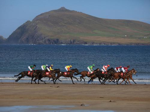 a group of people riding horses on the beach at Holiday Home Dingle Bay View - TR2 by Interhome in Emlagh East