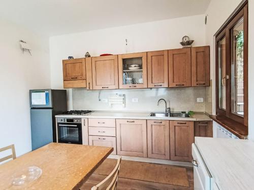 a kitchen with wooden cabinets and a wooden table at Villa Graziella by Interhome in Malcesine