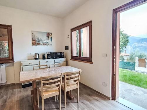 a kitchen with a table and chairs and a window at Villa Graziella by Interhome in Malcesine